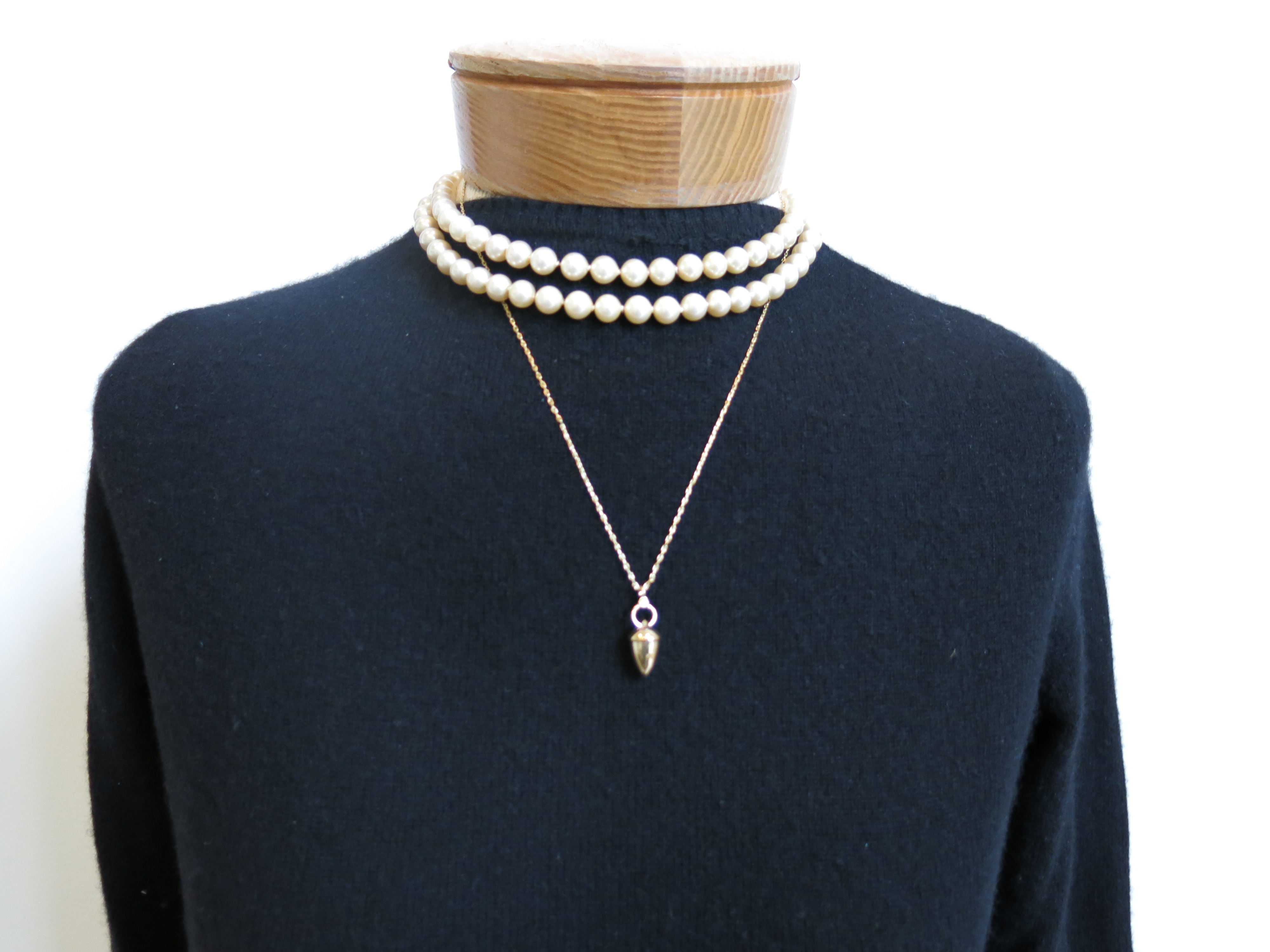 A pearl choker is too conservative to layer with a gold charm